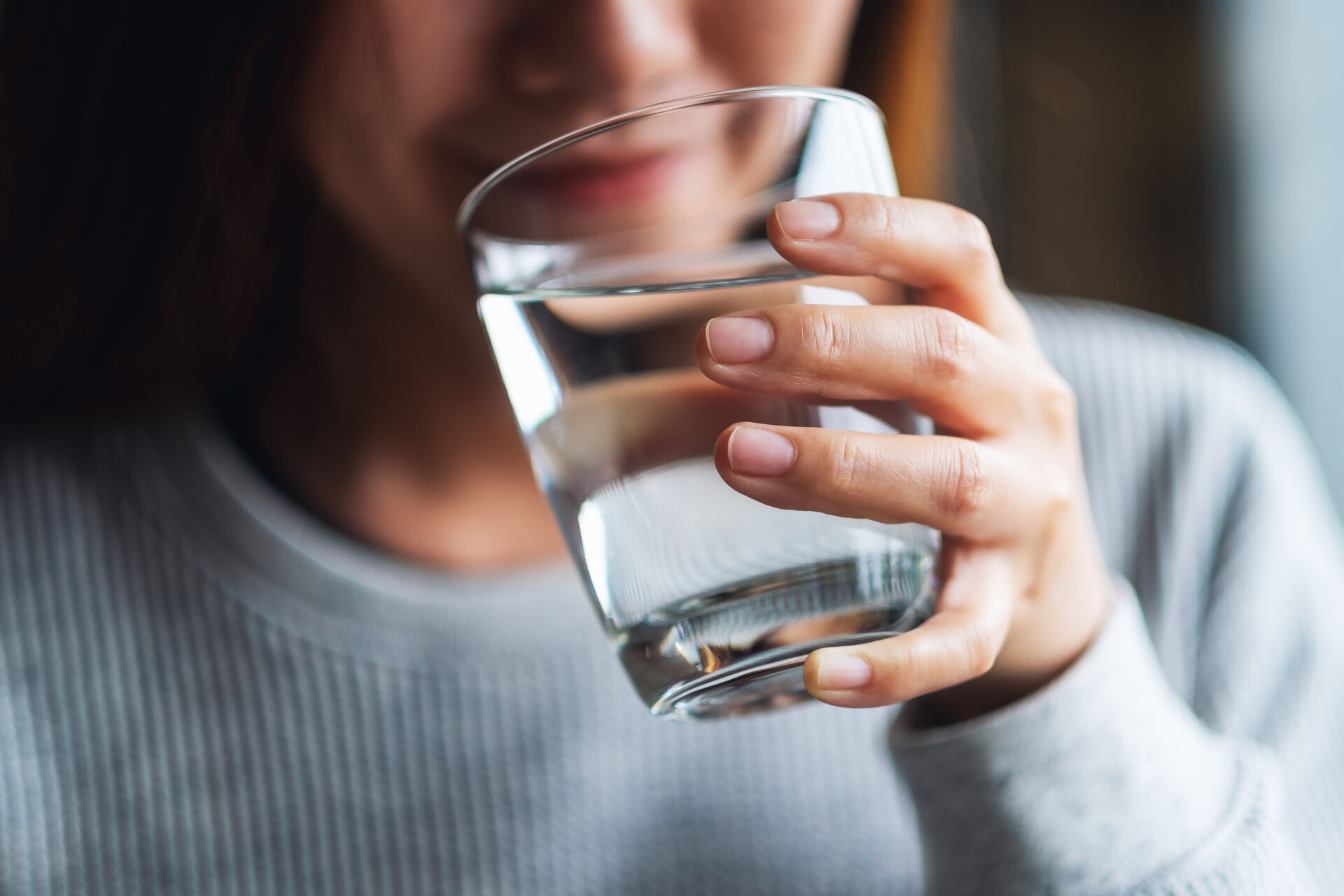 Woman enjoying pure filtered water